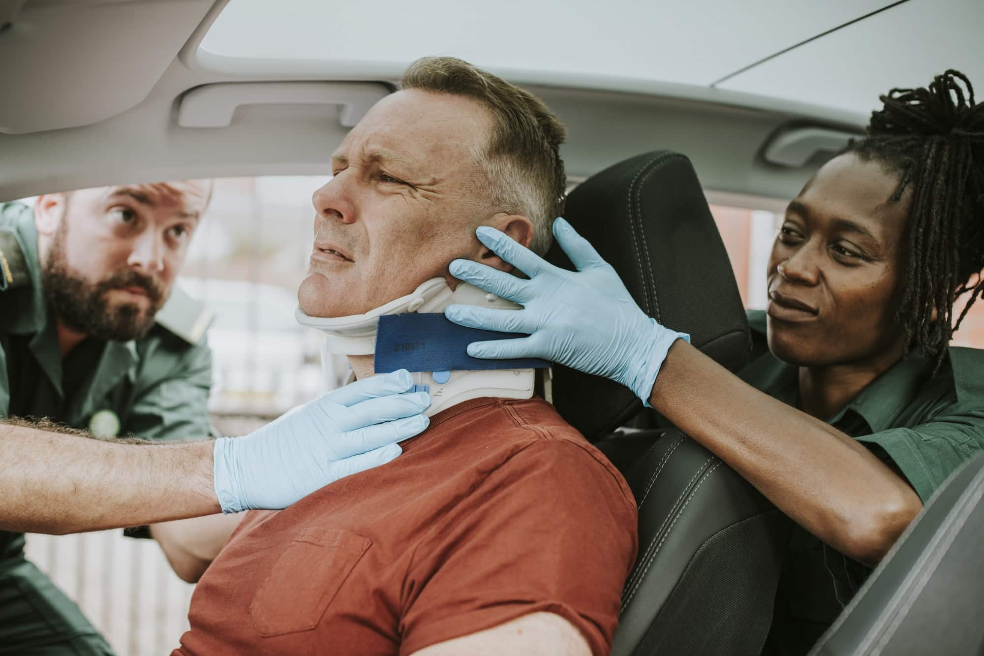 A person stretching the neck after a vehicle collision