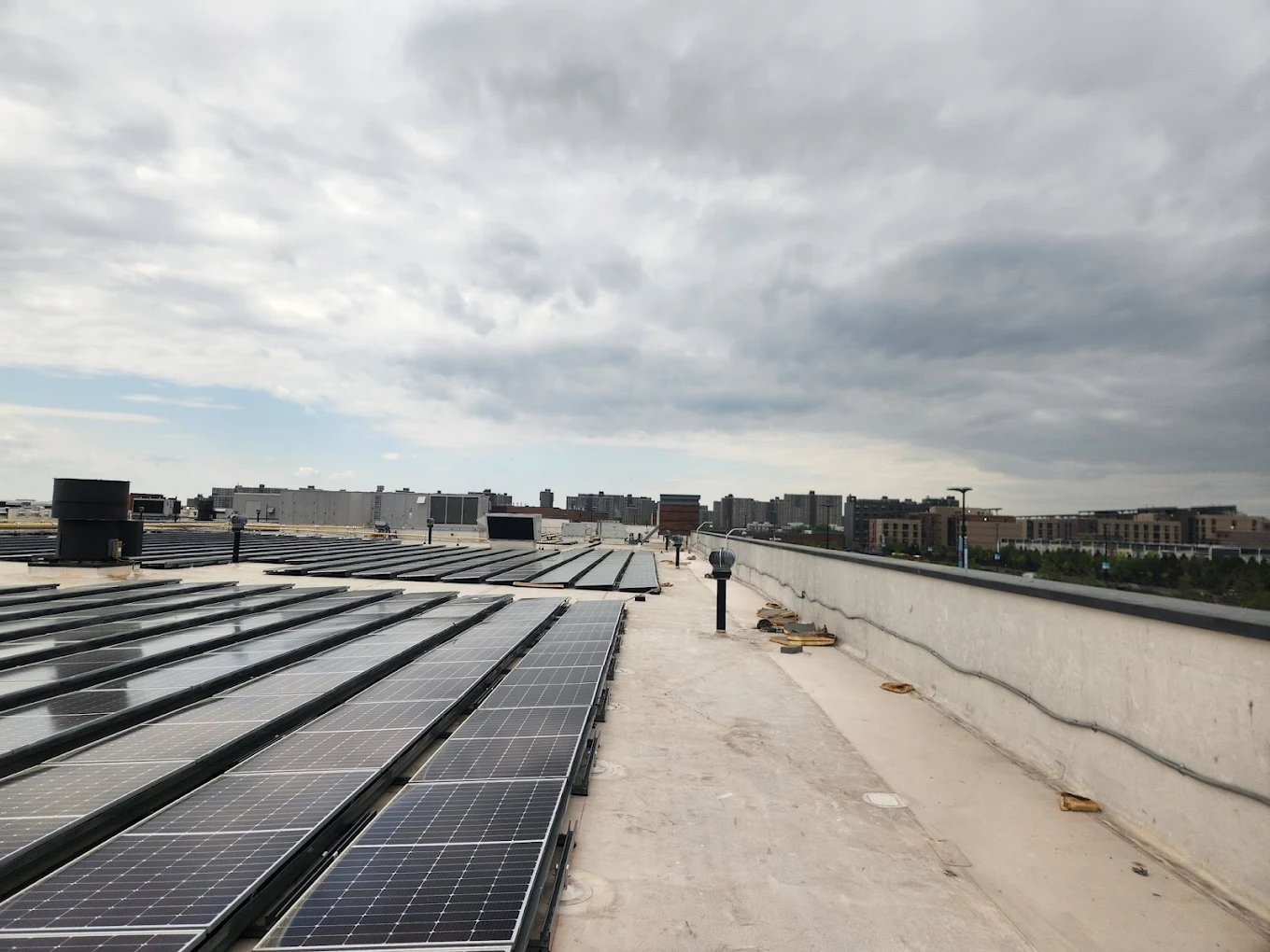 Completed TPO re-roofing project on commercial building in Long Island — white membrane with flashings visible